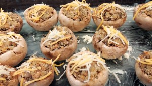 Stuffed mushrooms sprinkled with cheese ready for the oven